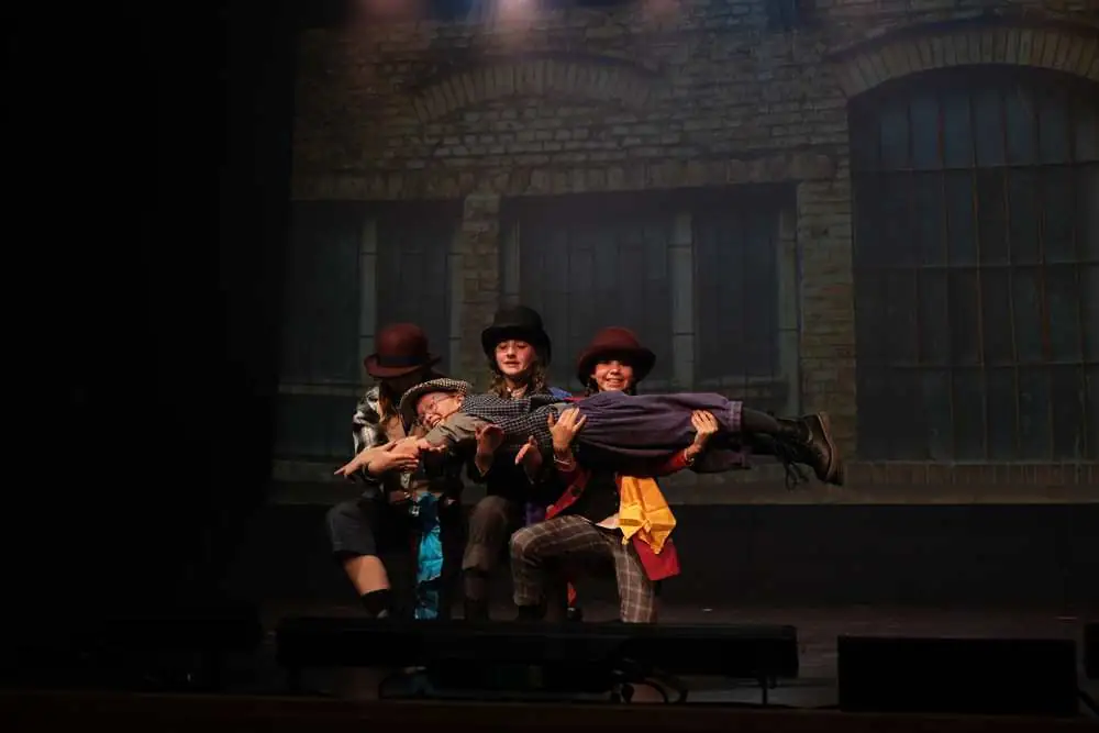 Performers lifting a castmate high