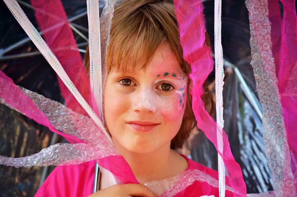 A performer in sparkly face paint
