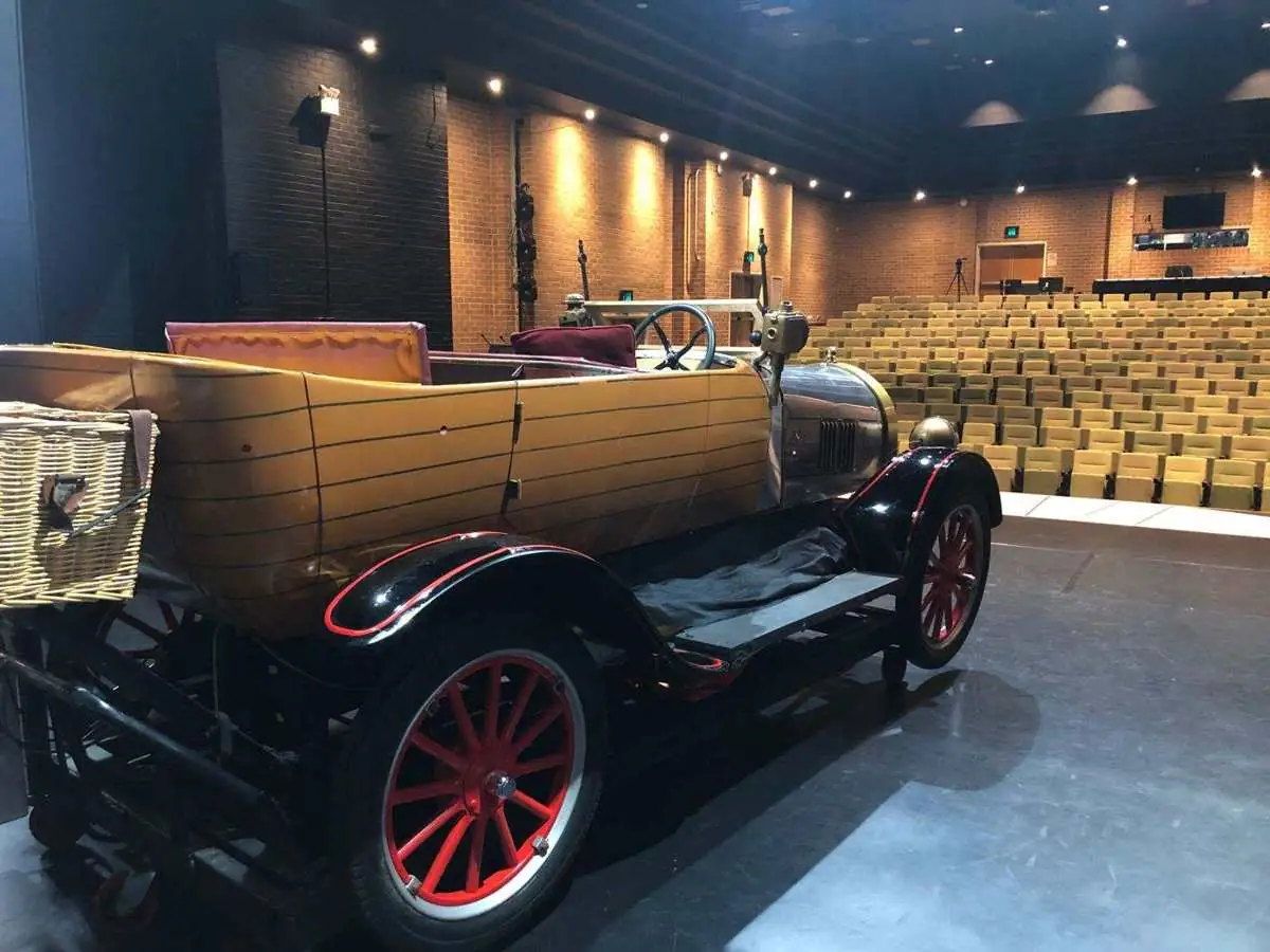 The Chitty car on a theatre stage facing the seating