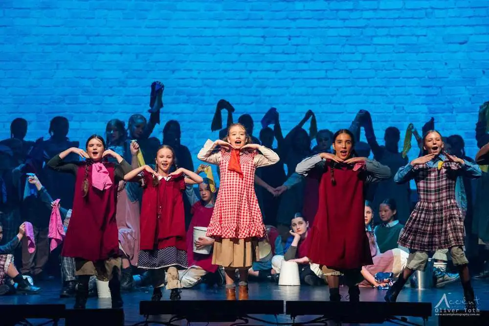Young performers in pinafores mid-number