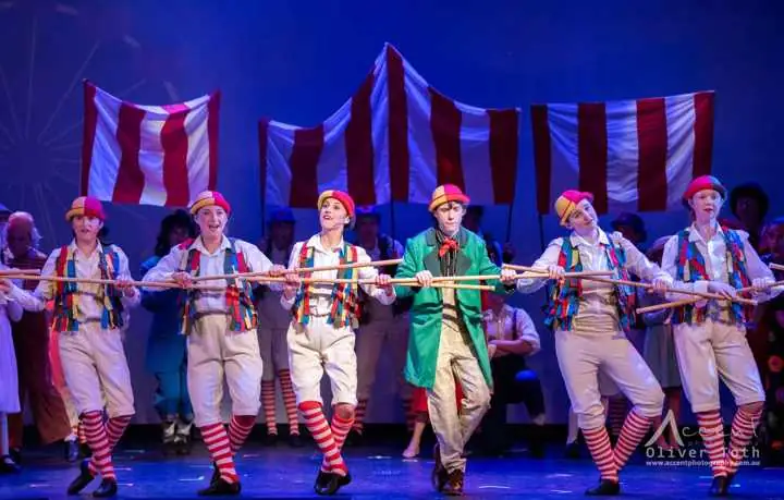 Chitty Chitty Bang Bang, 2025: the ensemble in striped costumes under a circus tent