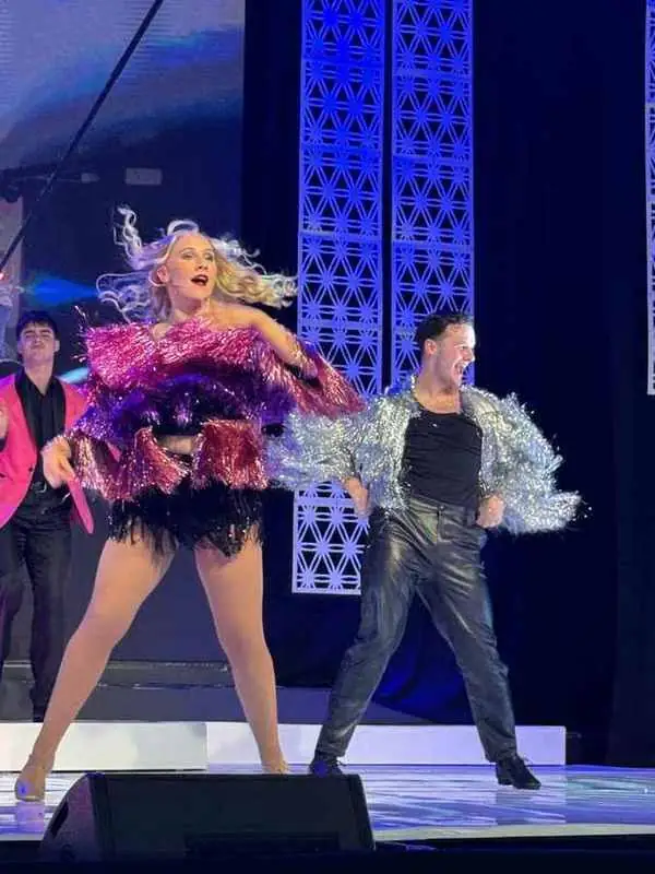 Two dancers in purple and silver feathers