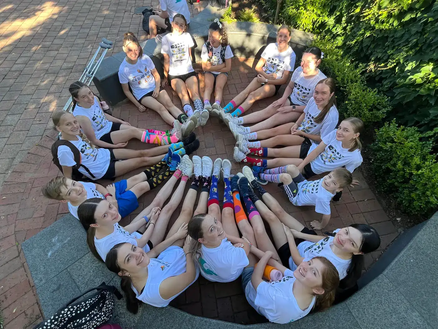 Campers in a circle showing off their colourful socks